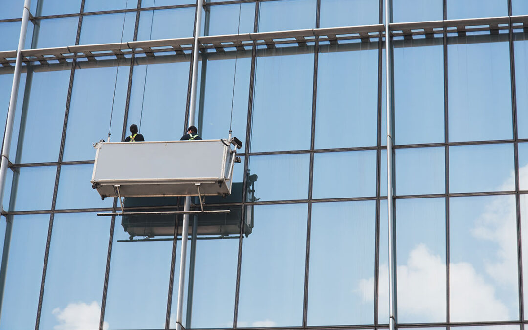window cleaners working on glass facade